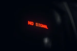 Dark screen displaying "no signal" error, representing a cybersecurity breach at a defense contractor